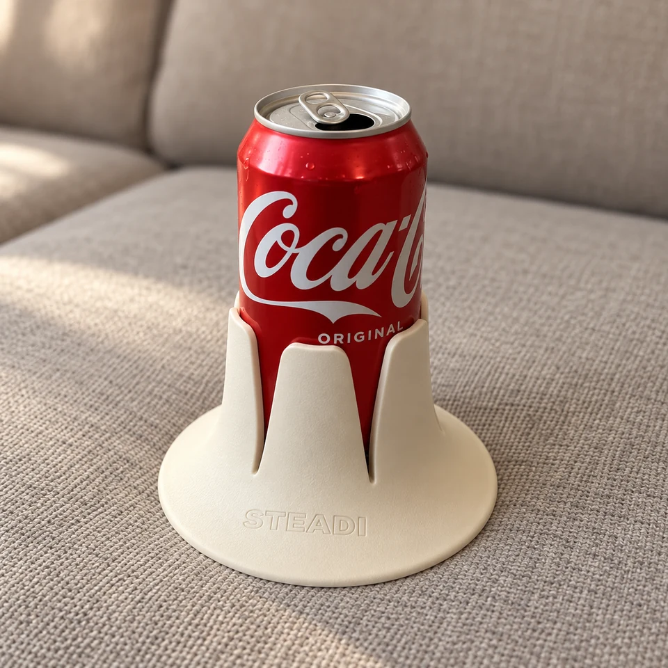An opened standard soda can seated in a cream Steadi, with the whole base visible